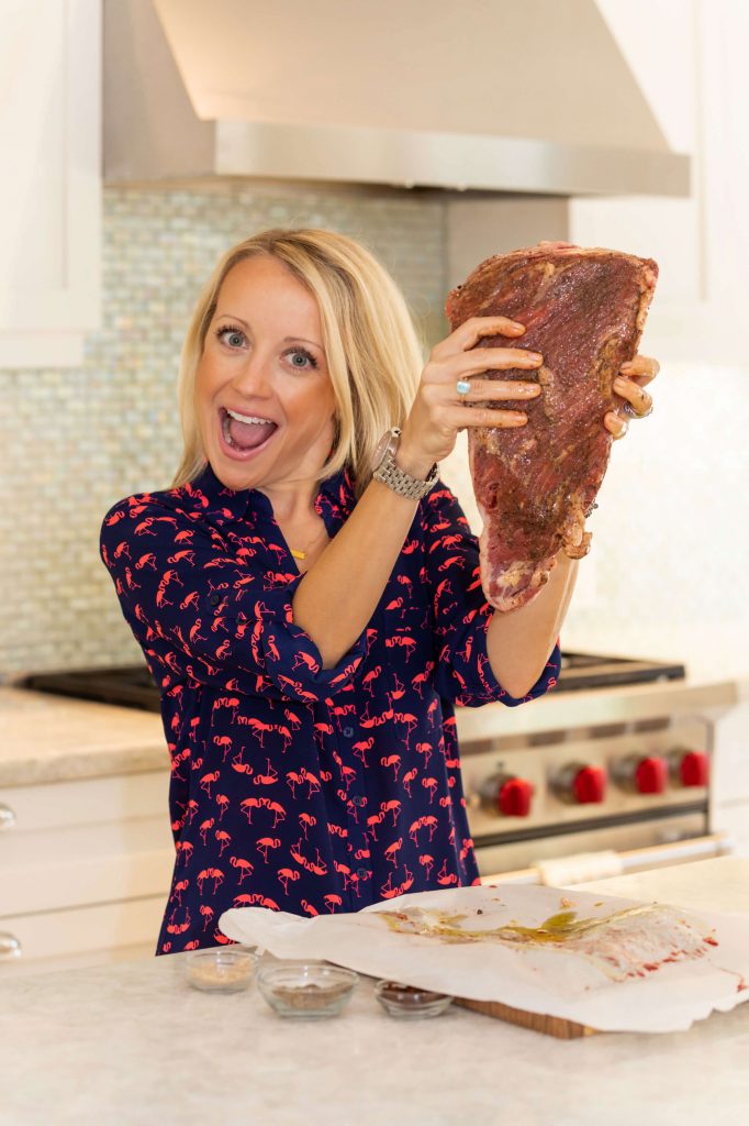 Robyn Lindars holding a large cut of meat.